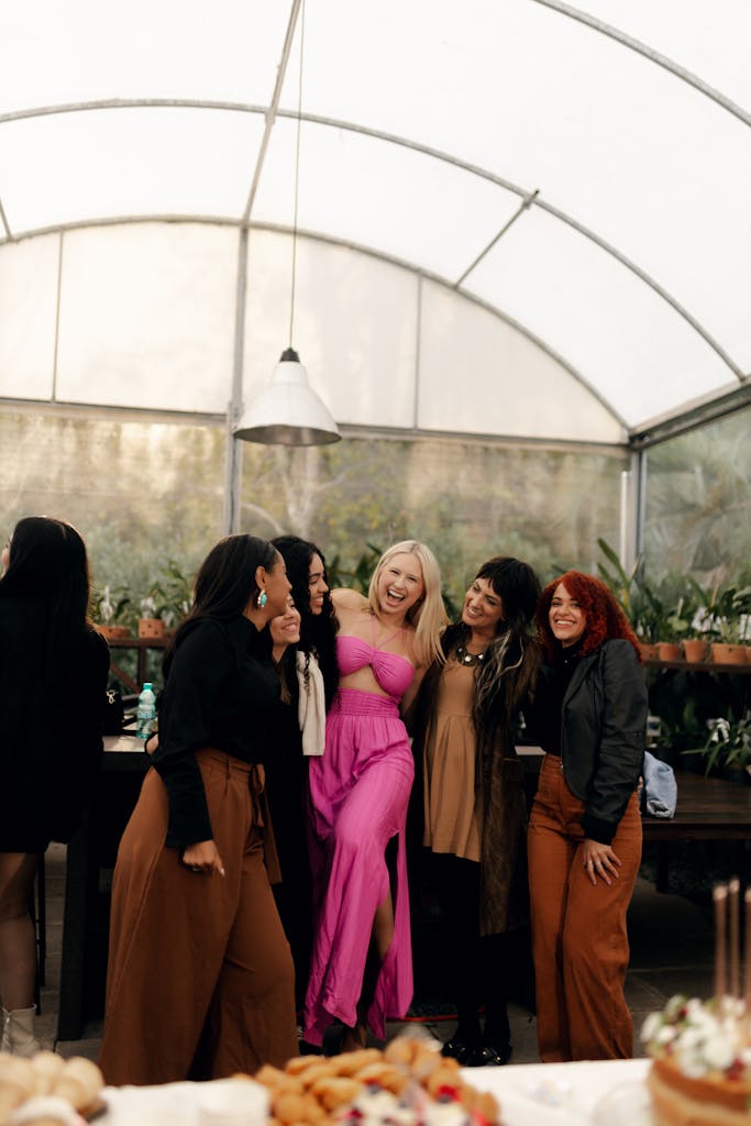 A group of friends joyfully celebrating indoors, showcasing happiness and unity.