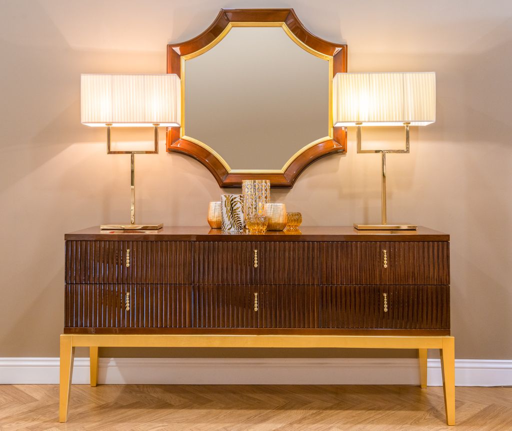 Luxurious wooden cabinet with modern lamps and mirror for contemporary interior design.