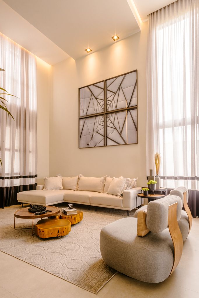 Stylish modern living room with high ceilings, minimalist decor, and neutral palette.